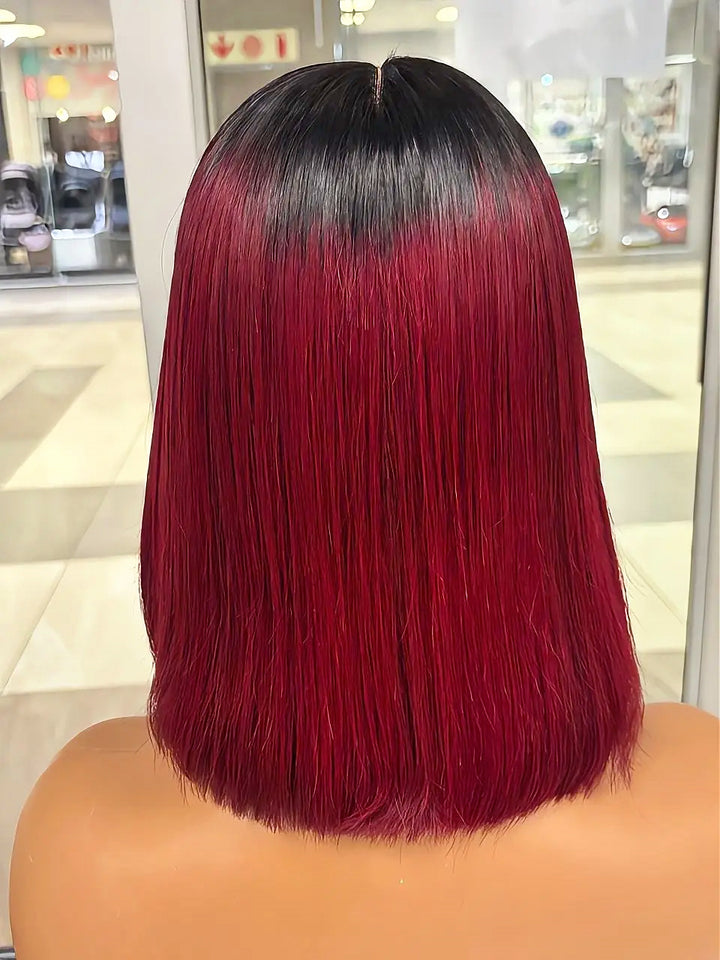 Rear view of a burgundy bob wig with black roots on a mannequin