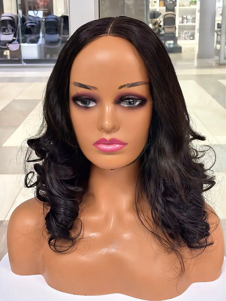 Black wig styled with a centre part and large curls on a mannequin